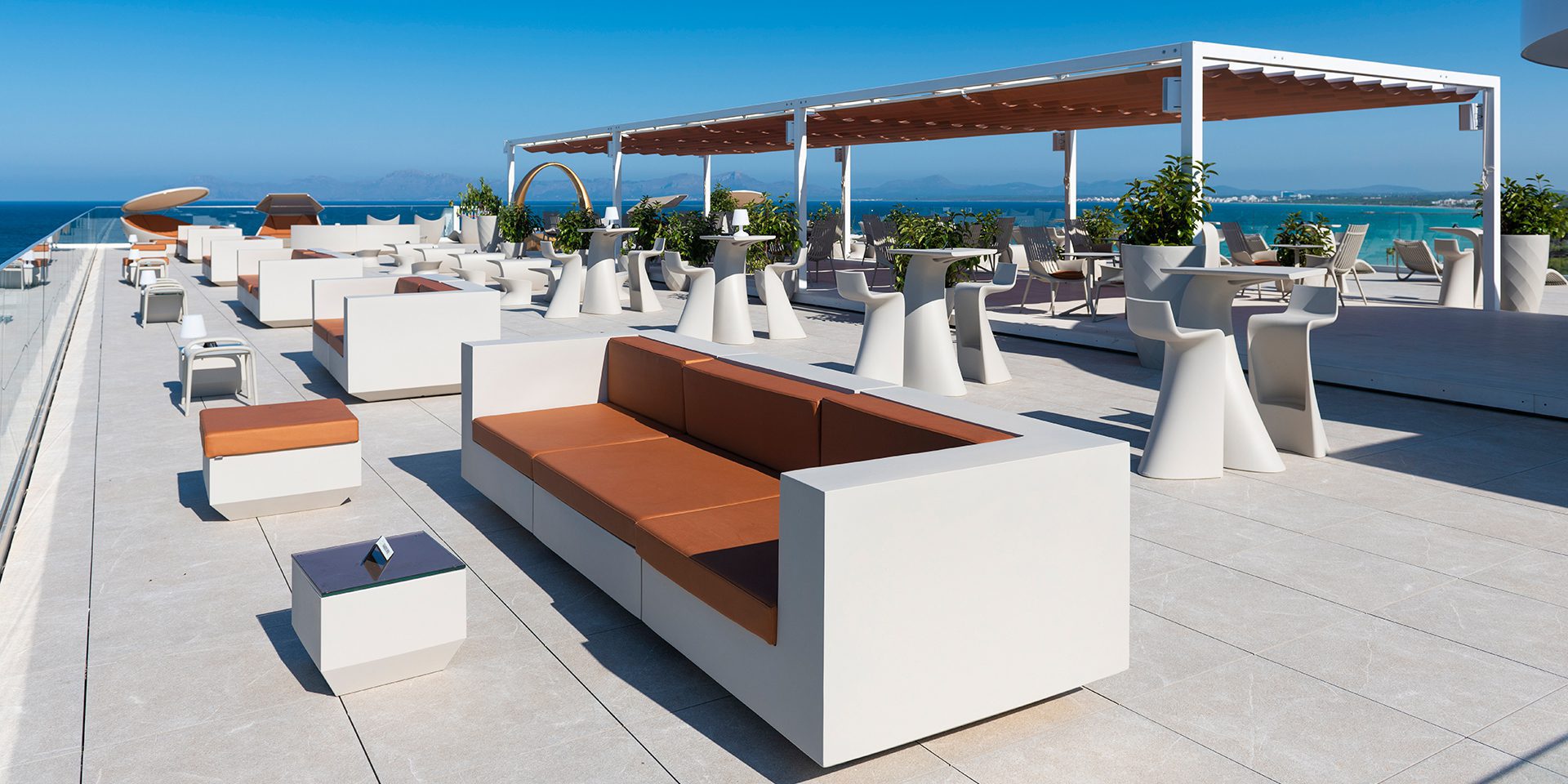 Outdoor contract furniture Vela sofa and Wing stools and tables, hospitality furniture by Vondom
